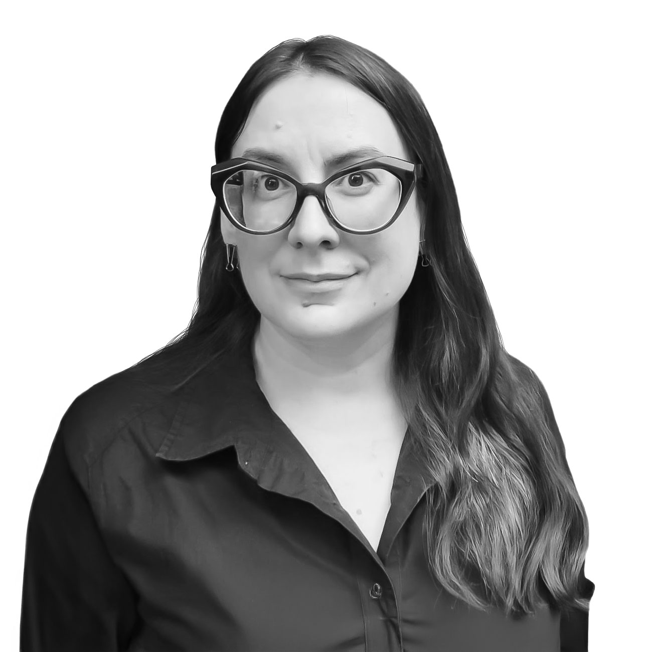 Portrait of a woman with long dark hair and large black glasses, wearing a dark blouse, smiling at the camera.
